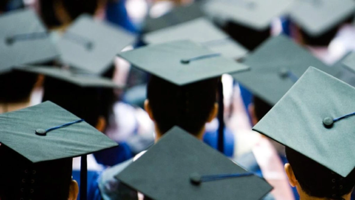 A group of people wearing academic caps, seen from behind