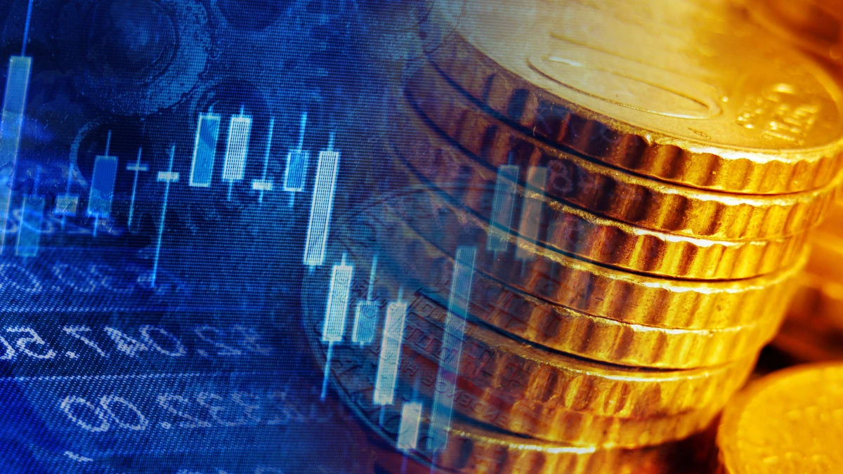 A photomontage of stacked gold-coloured coins and a market chart on a blue background