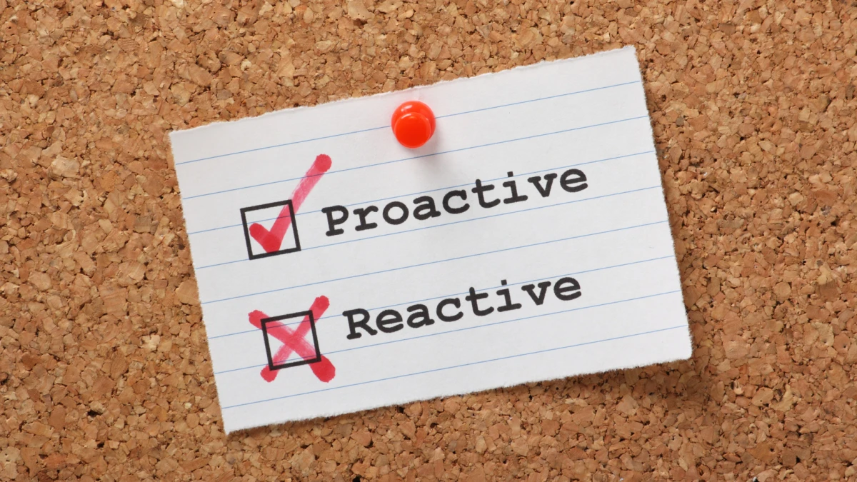 A card on a corkboard with Proactive checked and Reactive crossed out