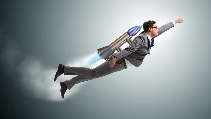 A photomontage of a man in a suit flying with a jetpack